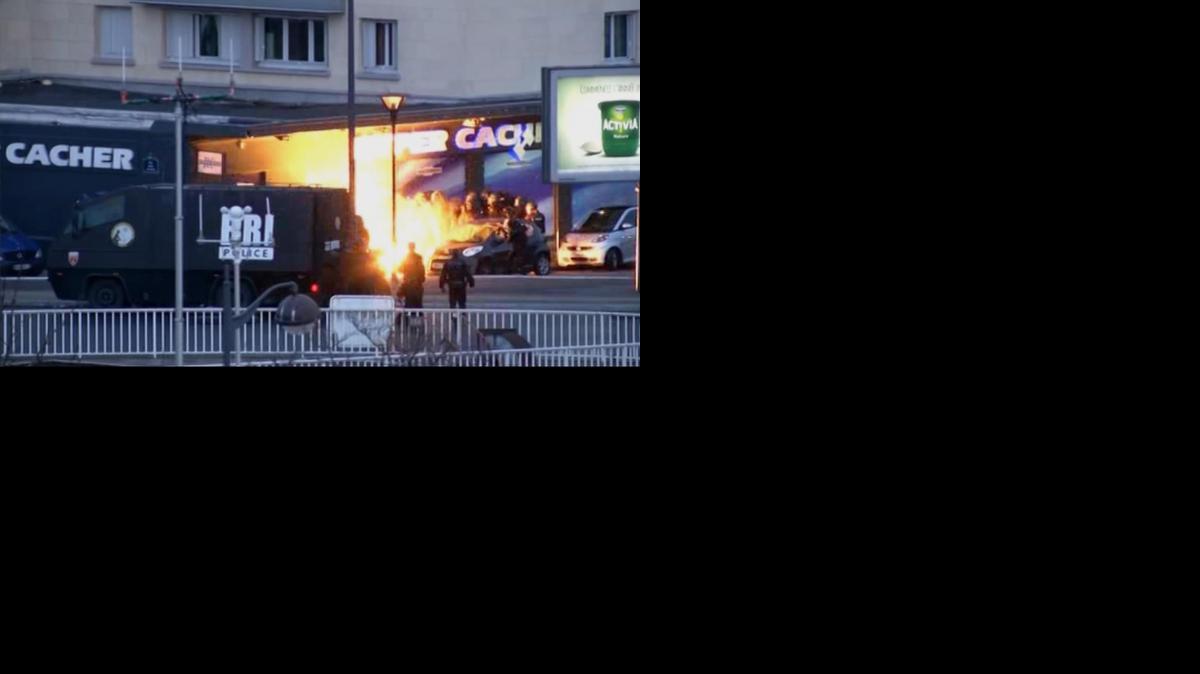 
Police officers storm a kosher grocery to end a hostage situation in this image made from TV in Paris, Friday. Terrorists who seized hostages at separate locations and ignited fear across Paris were killed Friday along with some of their hostages.

