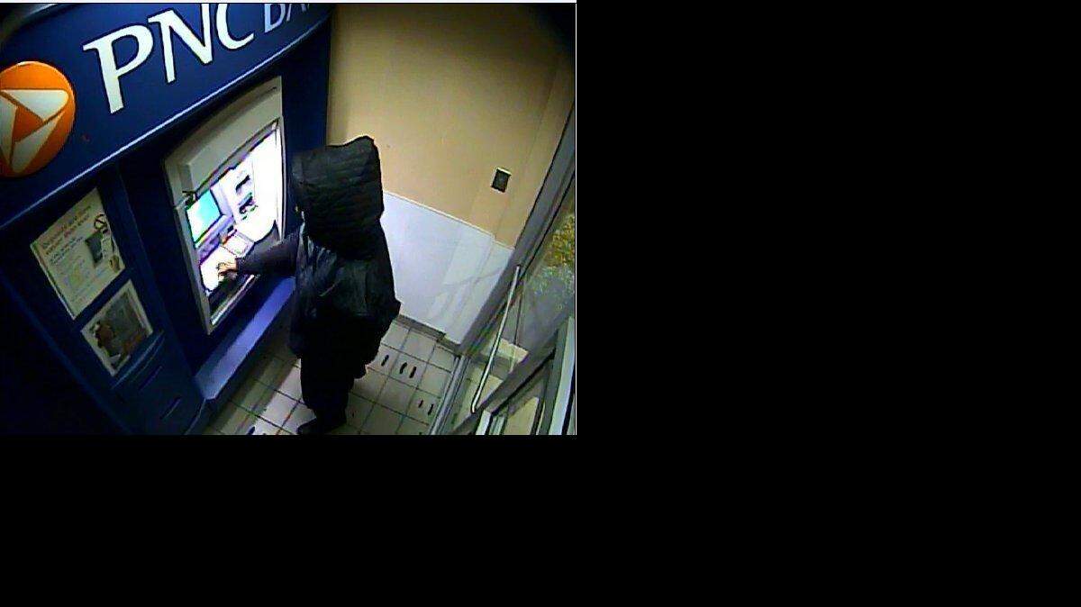 
This image taken from a surveillance video early Monday morning, Nov. 3, 2014, and released by the Philadelphia Police Department, shows an unknown man at an ATM machine in Aberdeen, Md., using Carlesha Freeland-Gaither's bank card. The transaction occurred less than nine hours after the reported abduction Sunday night, Nov. 2, of the Philadelphia woman. (AP Photo/Philadelphia Police Department) 
