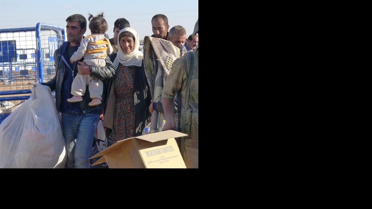 
Kurdish refugees arrive in Yumurtalik, Turkey, fleeing the advances of Islamic State extremists on the north Syrian city of Kobani, on Tuesday.
