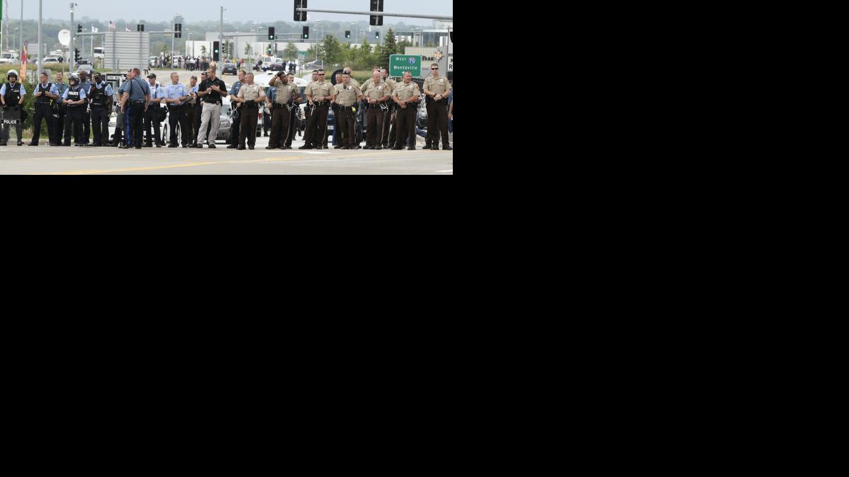 
A line of law enforcement officers block the road at a protest aimed at shutting down Interstate 70 in Berkeley, Mo., on Wednesday, near the St. Louis suburb of Ferguson, Mo. 
