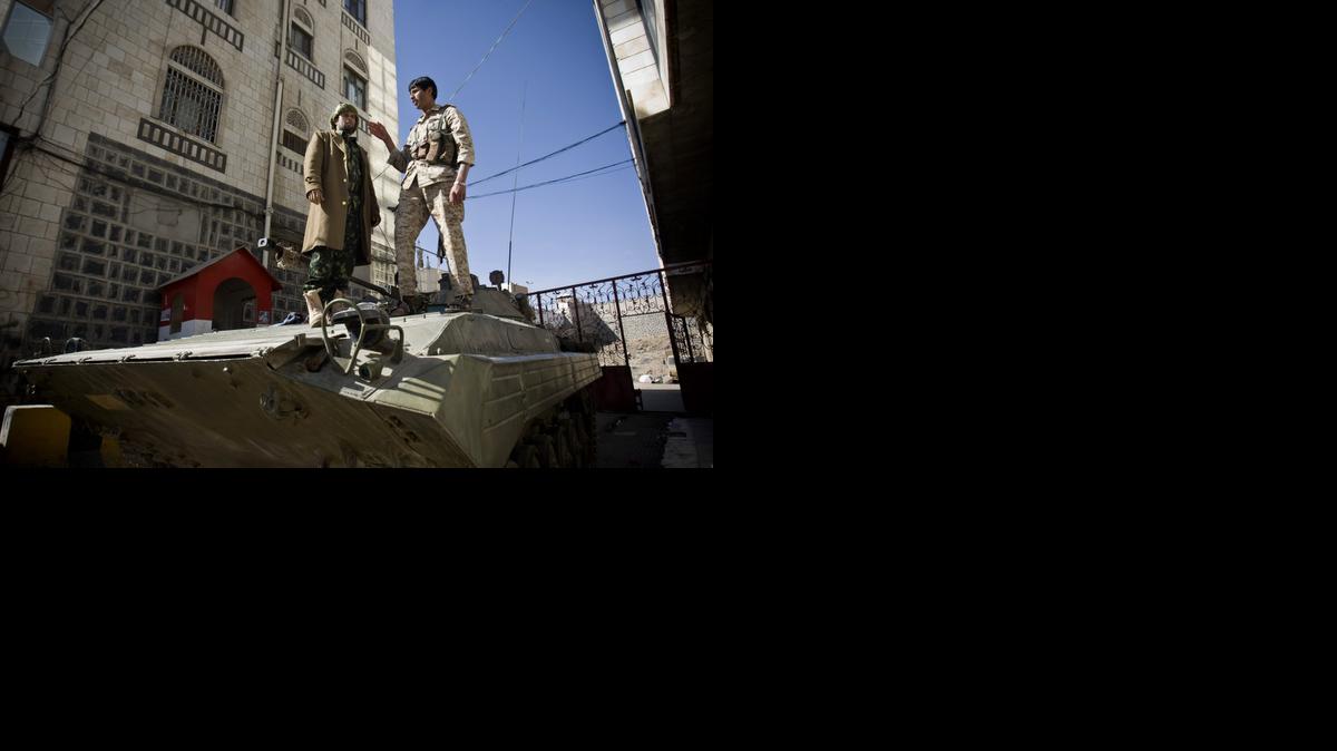 
Houthi Shiite Yemeni wearing army uniforms stand atop an armored vehicle, which was seized from the army during recent clashes, outside the house of Yemen's President Abed Rabbo Mansour Hadi in Sanaa, Yemen, Thursday.
