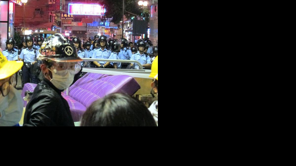 
A protester, ready for possible police tear gas, stands behind a barricade in Mong Kok, Hong Kong, China, in the early hours of Wednesday. Police and protesters clashed in the scruffy neighborhood for much of the day Tuesday.
