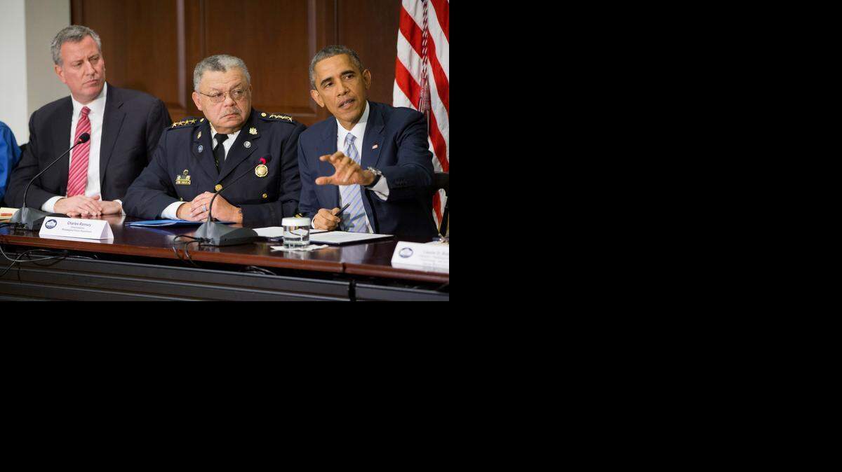 
President Obama, right, speaks during a meeting with elected officials, law enforcement officials and community and faith leaders on Monday at the White House. Also at the meeting were New York Mayor Bill de Blasio, left, and Charles Ramsey, commissioner of the Philadelphia Police Department. 

