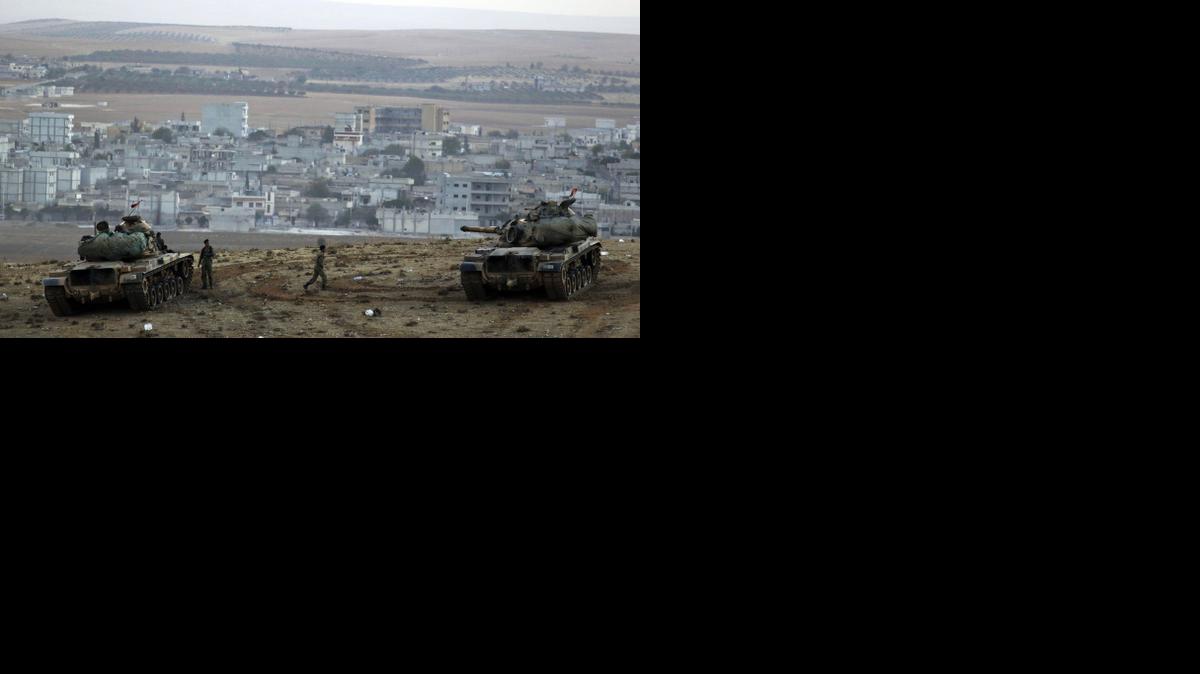 
Turkish soldiers hold their positions with their tanks on a hilltop on the outskirts of Suruc, at the Turkey-Syria border, overlooking Kobani, Syria, during fighting between Syrian Kurds and the militants of the Islamic State group, Friday.
