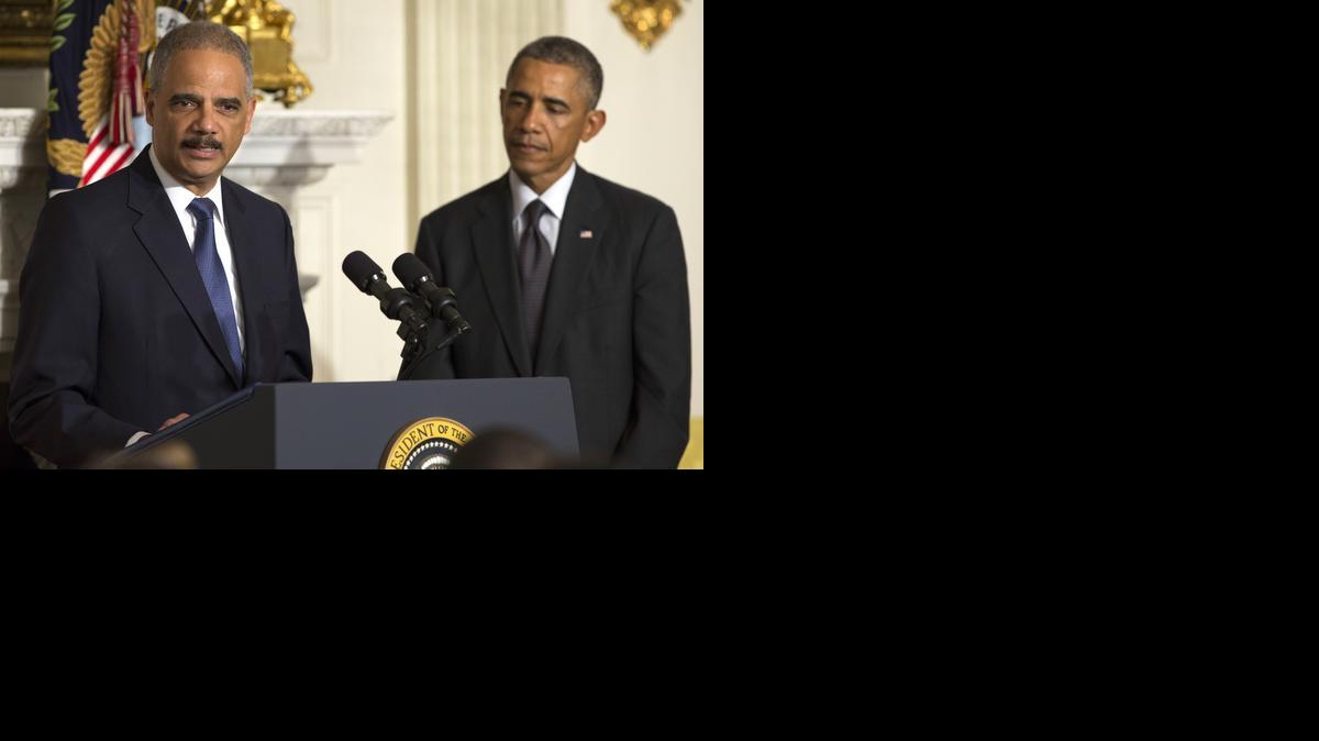 
President Obama listens as Attorney General Eric Holder speaks in the State Dining Room of the White House, on Thursday, Sept. 25, 2014, in Washington. 
