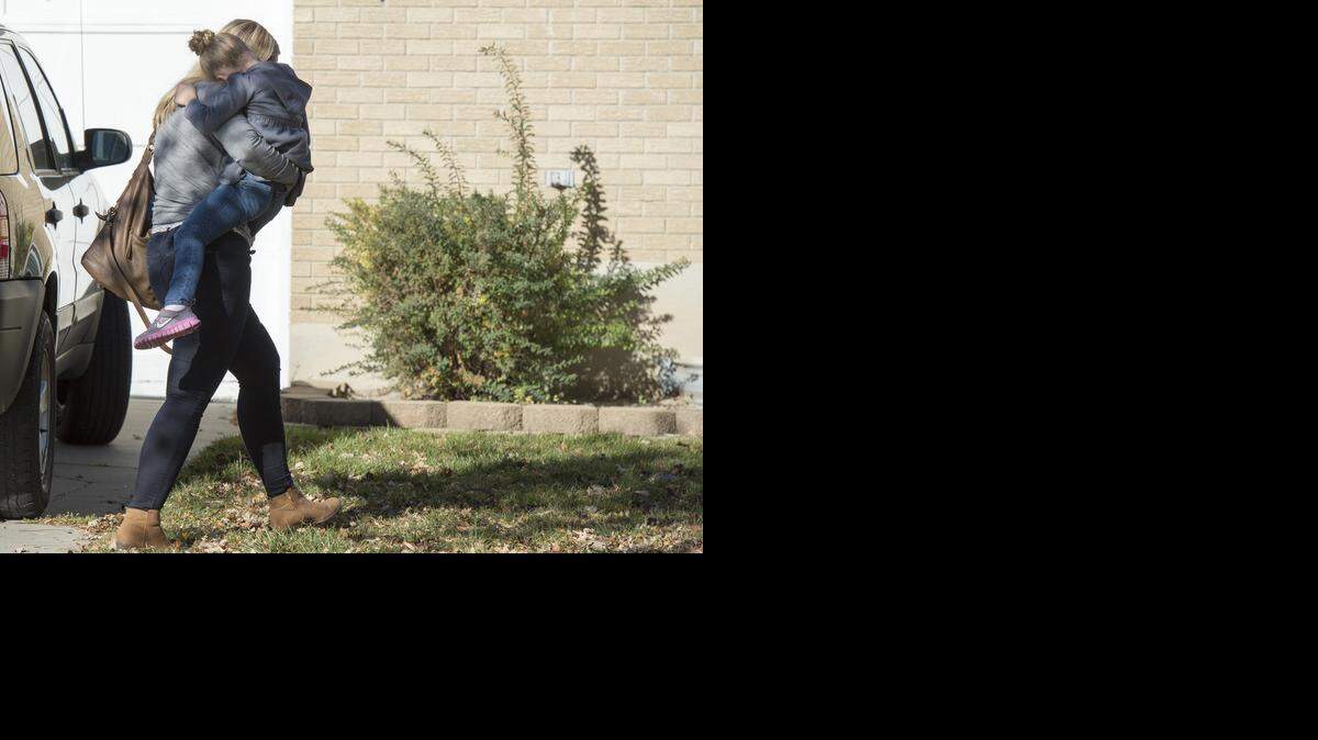 
A Sandy family returns home with their daughter after the girl's father rescued her from a man who tried to kidnap her on Friday, Nov. 7, 2014, in Sandy, Utah. The Utah dad foiled an attempt to kidnap his young daughter from her bed early Friday after confronting a man carrying her across the lawn. 
