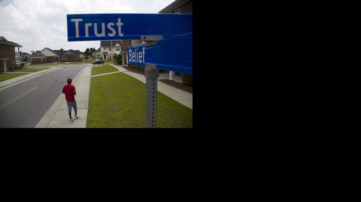
Bryan Melvin walks near the intersection of Trust Drive and Belief Lane at Campbell Terrace affordable housing in east Fayetteville. Payroll records show many of the workers who worked on the project were improperly treated as contractors. 
