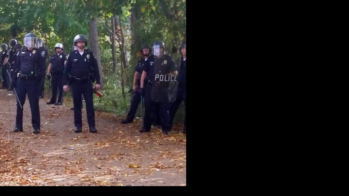 
In this photo provided by Seth Meyer, police officers line up. Local police, firefighters and ambulances in New Hampshire responded to large crowds of students as the annual Pumpkin Festival is underway near Keene State College Saturday, Oct. 18, 2014. Media report several people have been injured in an apparent Saturday afternoon melee. 
