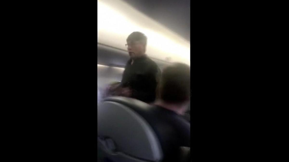 This April 9, 2017, image made from a video provided by Audra D. Bridges shows a passenger who was removed from a United Airlines flight in Chicago. Video of police officers dragging the passenger from an overbooked United Airlines flight sparked an uproar Monday on social media, and a spokesman for the airline insisted that employees had no choice but to contact authorities to remove the man. (Audra D. Bridges via AP)