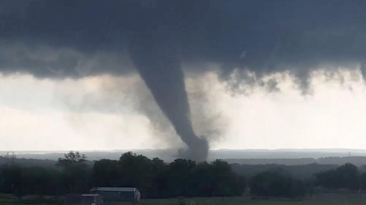 This image made from a video taken through a car window shows a tornado near Wynnewood, Okla., Monday, May 9, 2016. A broad tornado capable of leaving “catastrophic” damage in its wake churned across the Oklahoma landscape Monday, prompting forecasters to declare a tornado emergency for two communities directly in its path. (Hayden Mahan via AP)