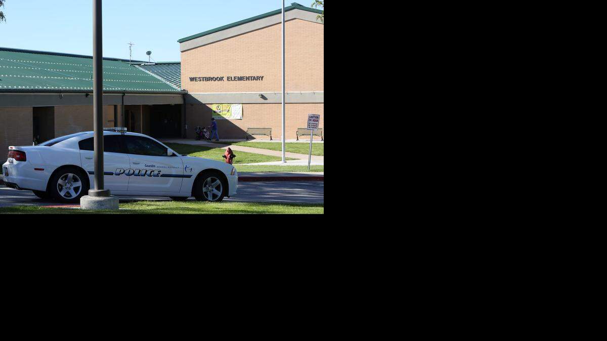 
A police car is parked in front of Westbrook Elementary School in Taylorsville, Utah, Thursday, Sept. 11, 2014, where a teacher’s gun accidentally went off, while she was alone in a faculty bathroom, shortly before school started. 
