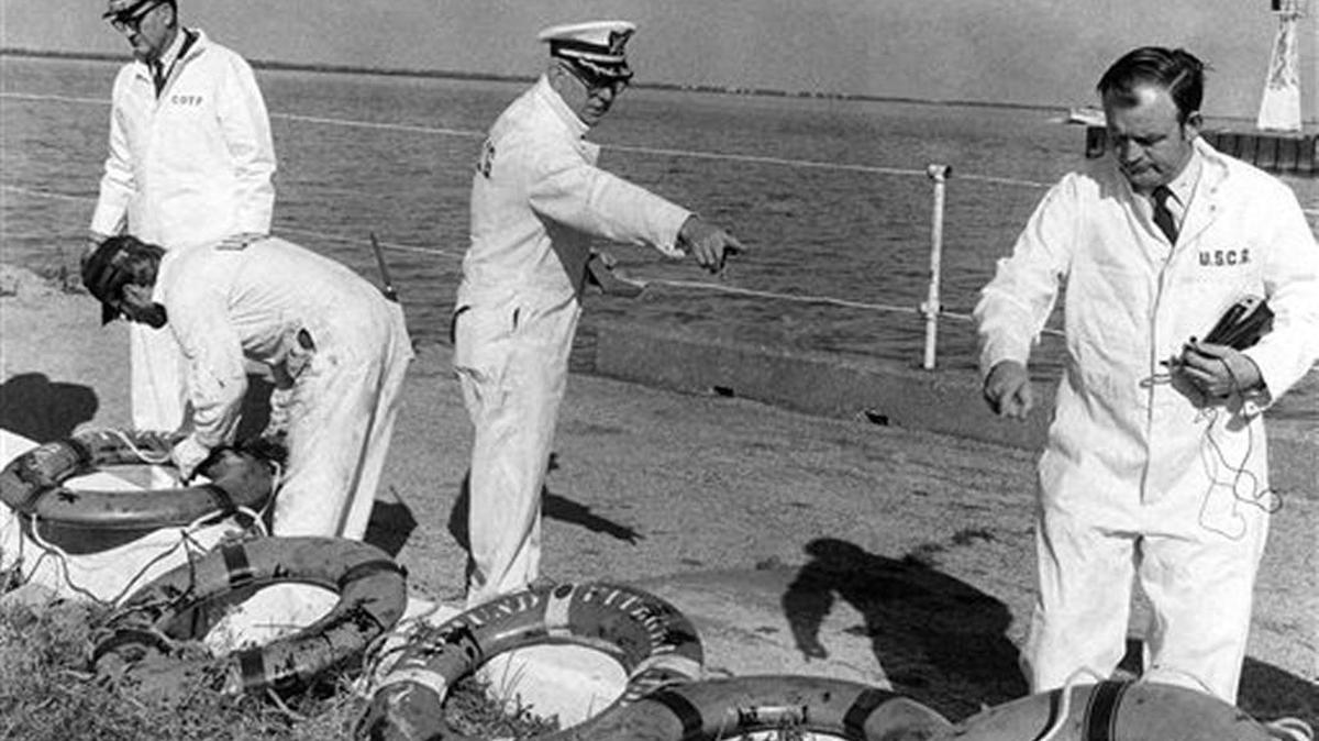 In a Nov. 24, 1975 file photo Coast Guard officers on a Board of Inquiry inspected life rings that were recovered from the ore carrier Edmund Fitzgerald, which sank in stormy weather in Lake Superior on Nov. 10, 1975. All 29 crewmen aboard perished and did not get a chance to use any of the lifesaving equipment. The Great Lakes have claimed some 6,000 ships since European explorers began navigating the waters in the 1600s, but few have captured the publics imagination as has the Edmund Fitzgerald.