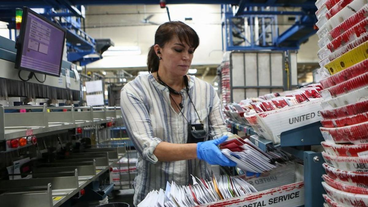 Martha Aguilar, a mail clerk, sorts through letters last year at a post office in Miami.