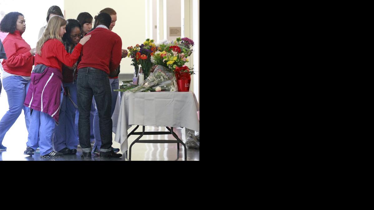 
Students pay their respects at a makeshift memorial at the UNC School of Dentistry in the wake of the murder of Deah Shaddy Barakat and his wife Yusor Abu-Salha and Abu-Salha's sister, Razan Abu-Salha on Wednesday in Chapel Hill, N.C.

