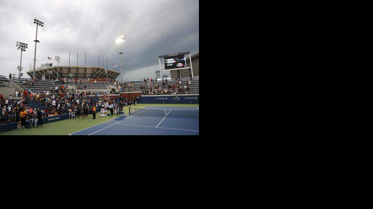 
Play is suspended as storm clouds roll over the Billie Jean King National Tennis Center because of imminent lighting during the 2014 U.S. Open tennis tournament, Sunday, Aug. 31, 2014, in New York. (AP Photo/Elise Amendola) 
