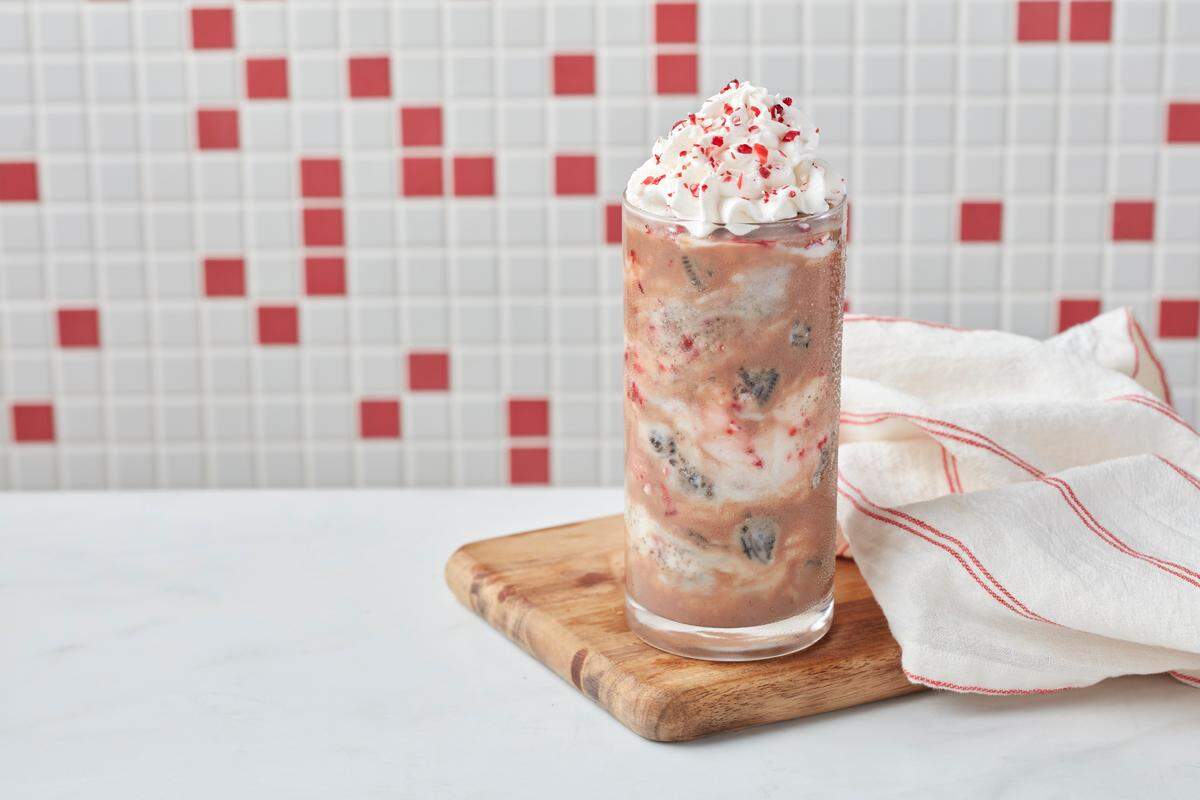 Freddy’s Oreo cookie peppermint concerete is made with chocolate and vanilla frozen custard swirled with peppermint syrup, chocolate cookie crumbles and peppermint candy pieces.