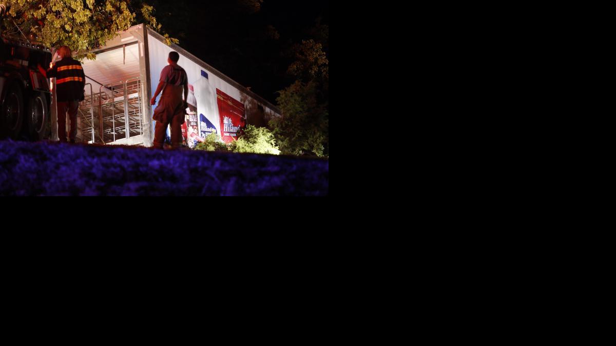 
Wrecker drivers pull the trailer of a semi from a ravine at the scene of a fatality accident just south of the Turner Falls area on Saturday, Sept. 27, 2014 in Davis, Okla. Four members of a Texas college softball team died after a tractor trailer crossed over the center median on Interstate 35 and collided with the team's bus Friday night. (AP Photo/The Oklahoman, Steve Sisney) 

