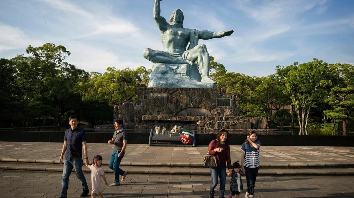 Tourists visit the Peace Statue in the Nagasaki Peace Park, built in 1955 to commemorate the atomic bombing of the city. That Nagasaki was bombed second after Hiroshima during World War II has made it an afterthought in the history of and debate over nuclear weapons.