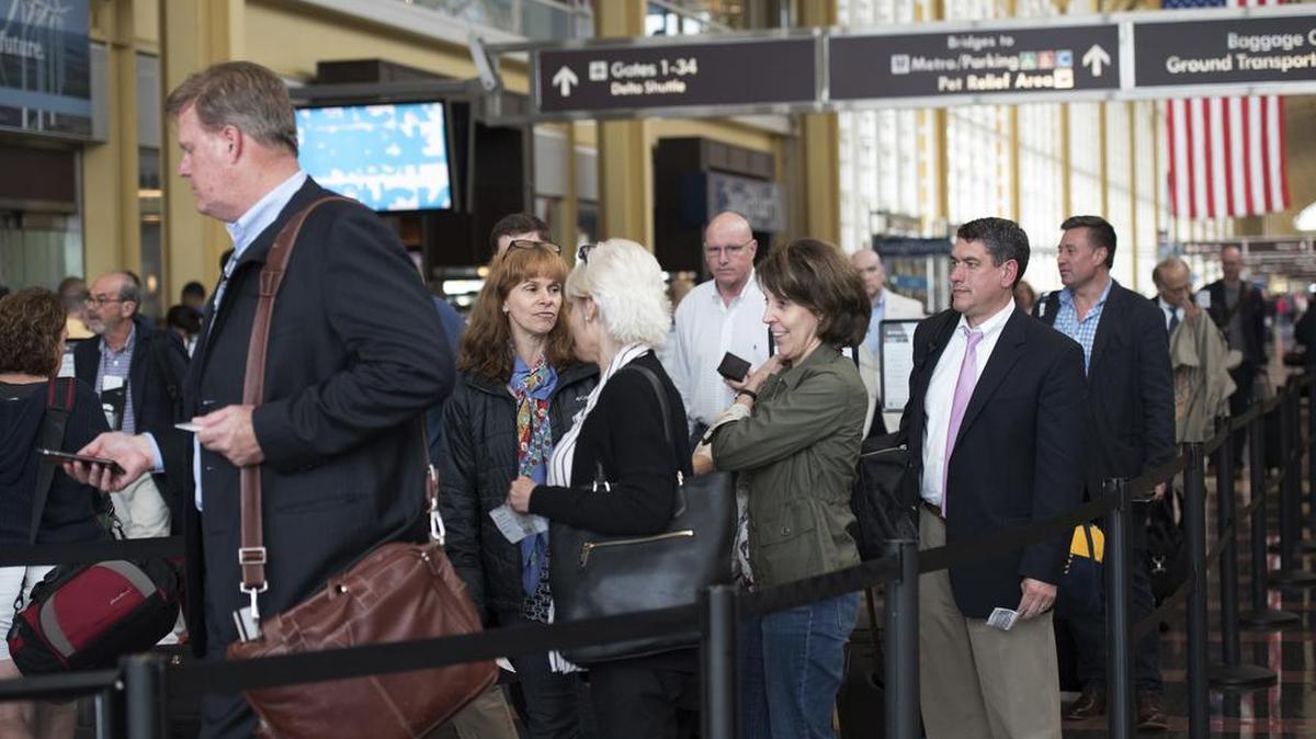 Passengers wait in a security line Friday at Ronald Reagan National Airport in Washington, D.C. Fliers across the country have been facing growing lines, which during peak hours have topped 90 minutes at some airports.