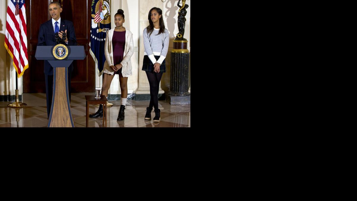 
President Obama, joined by his daughters Malia, right, and Sasha, center, speaks at the White House om Wednesday during the presidential turkey pardon ceremony. 

