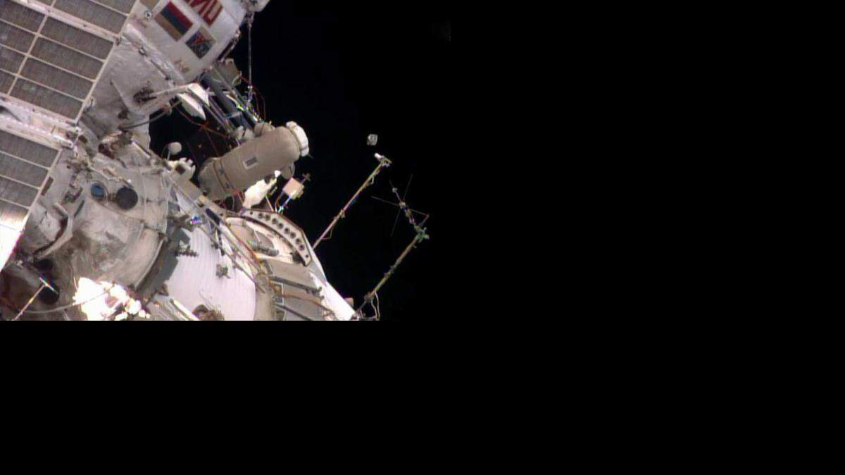 
This photo provided by NASA shows a tiny Peruvian research satellite, right of center, launched by spacewalking astronauts aboard the International Space Station (Aug. 18, 2014)
