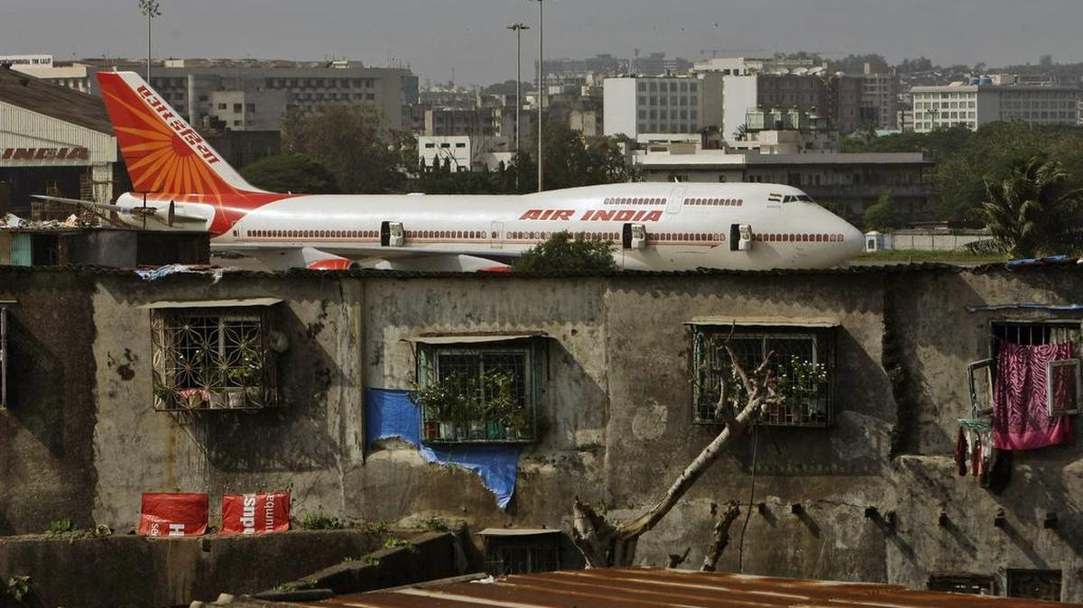 In this May 25, 2010, file photo, an Air India plane is seen in the background of slums adjoining the international airport in Mumbai, India. India is forecast to become the third largest aviation market by 2020.