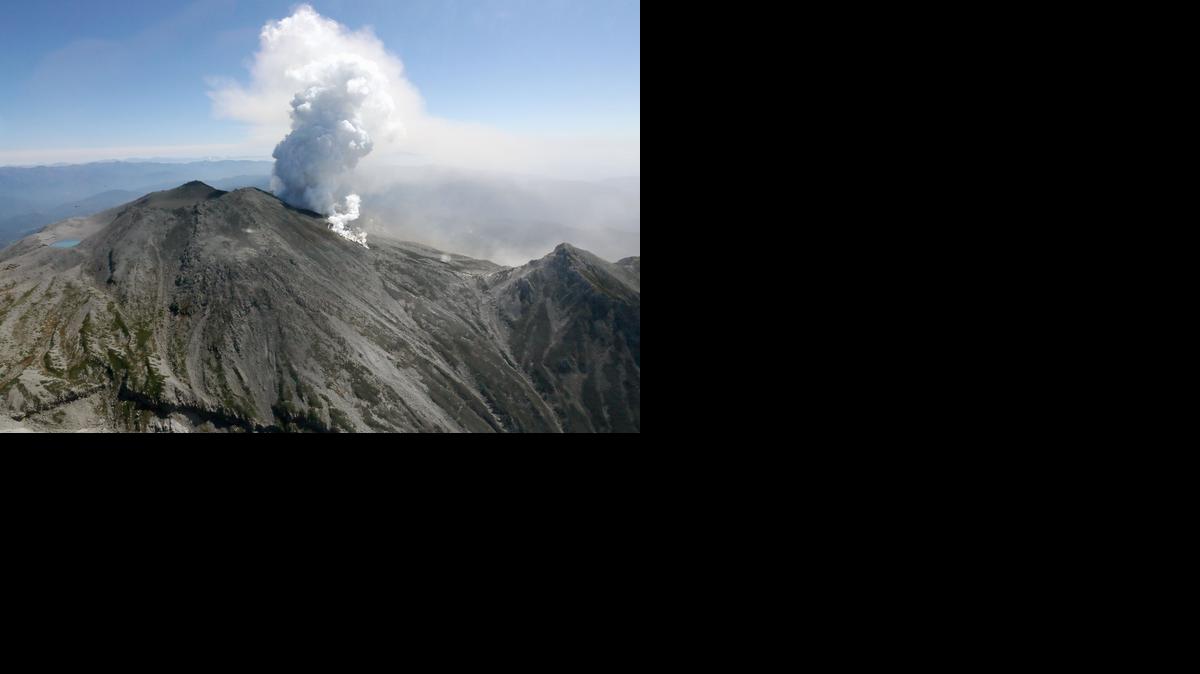 
Plumes of smoke and ash billow from Mount Ontake in central Japan, Sunday, Sept. 28, 2014 Sunday, Sept. 28, 2014. Mount Ontake erupted shortly before noon Saturday, spewing large white plumes of gas and ash high into the sky and blanketing the surrounding area in ash. Rescue workers on Sunday found more than 30 people unconscious and believed to be dead near the peak of an erupting volcano, a Japanese police official said. (AP Photo/Kyodo News) JAPAN OUT, MANDATORY CREDIT 
