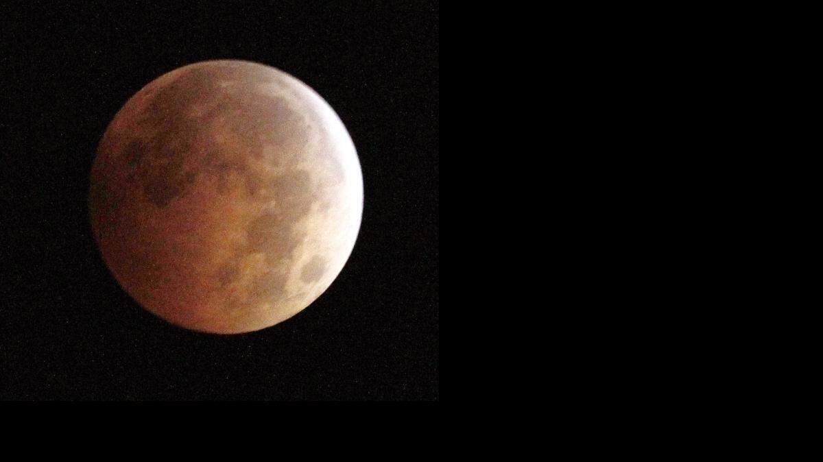 
The Blood Moon, created by the full moon passing into the shadow of the earth during a total lunar eclipse, as seen from Monterey Park, Ca., on Wednesday morning, Oct. 8, 2014. (AP Photo/ Nick Ut ) 

