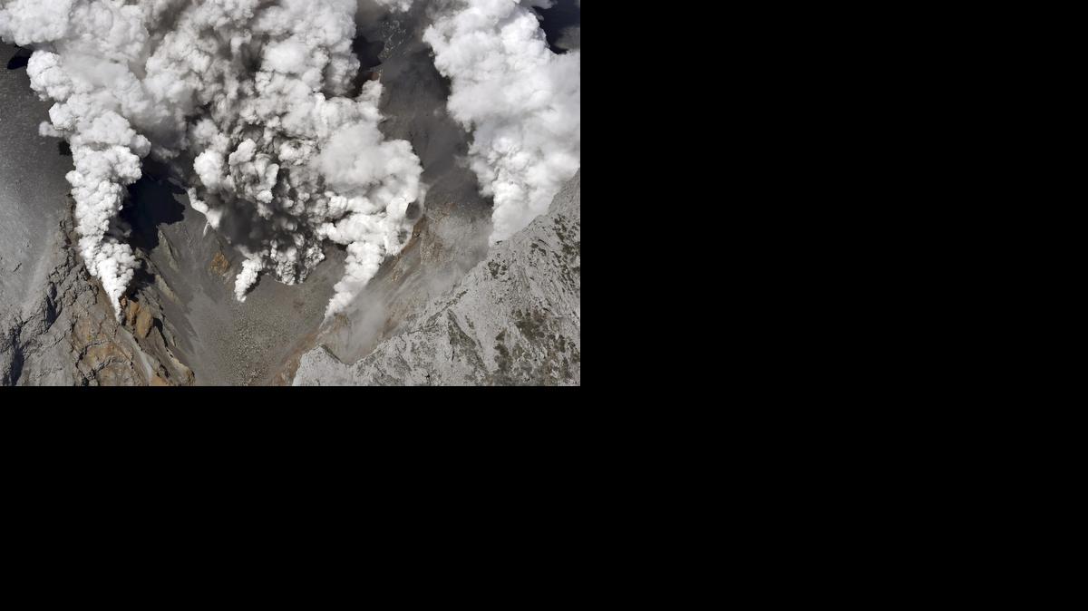 
Dense fumes are spewed out from several spots on the slope of Mt. Ontake as the volcano erupts in central Japan Saturday, Sept. 27, 2014. Mt. Ontake erupted Saturday, sending a large plume of ash high into the sky and prompting a warning to climbers and others to avoid the area. Japanese broadcaster NHK, citing local authorities, said there were reports of injuries, but no word on their severity. It also reported that people had been evacuated from a mountain lodge. (AP Photo/Yomiuri Shimbun, Toshihiko Kawaguchi) JAPAN OUT, CREDIT MANDATORY 
