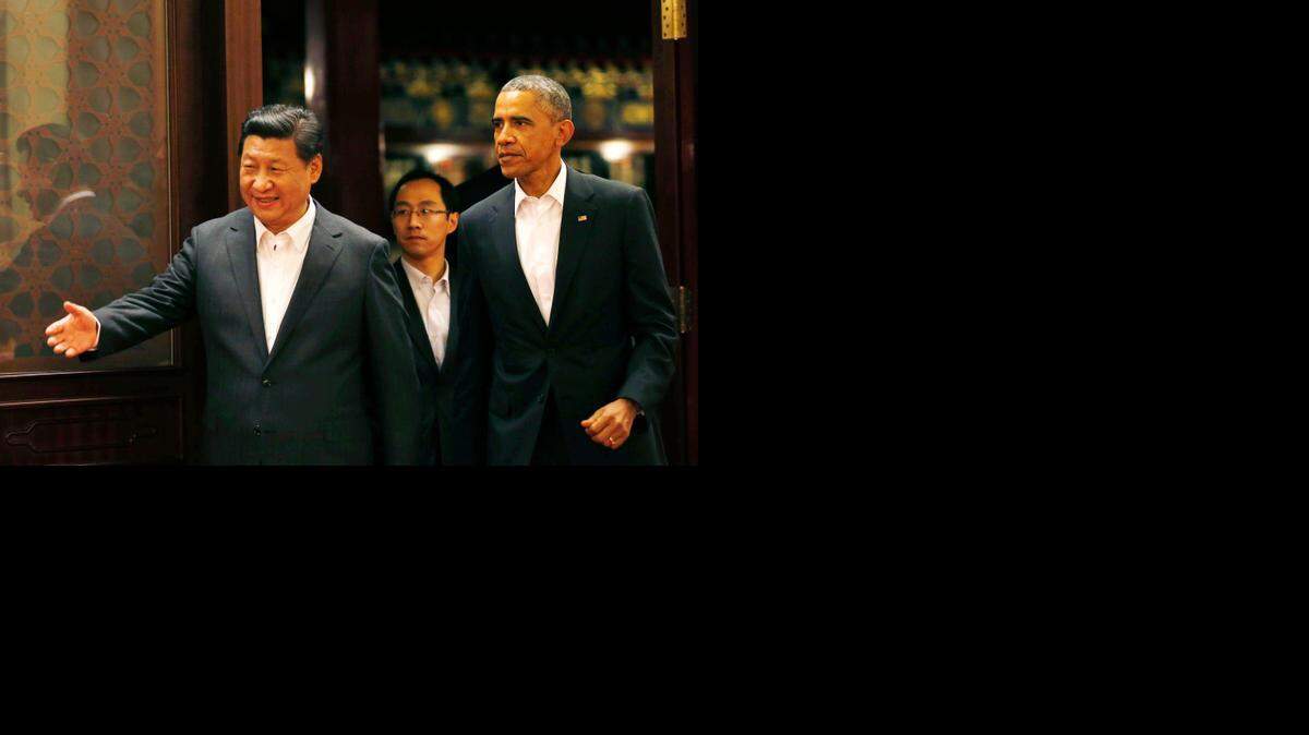 
Chinese President Xi Jinping, left, leads President Obama to a meeting after participating in the Asia Pacific Economic Cooperation summit in Beijing. (Nov. 11, 2014)
