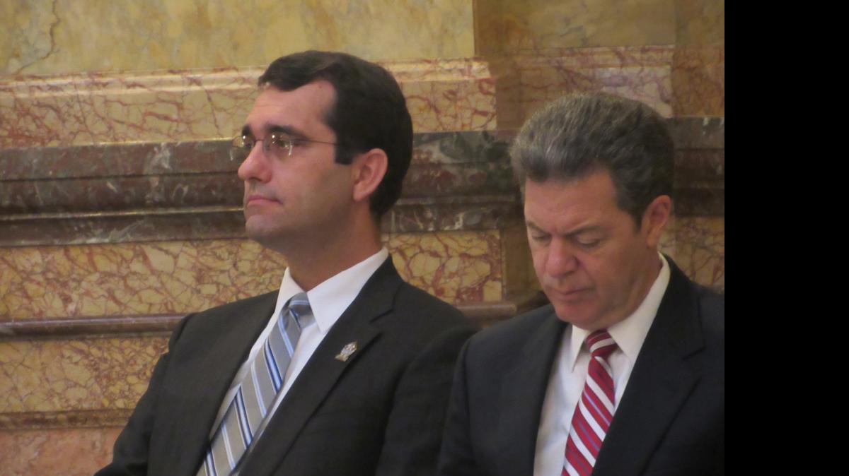 
Attorney General Derek Schmidt, left, sits with Gov. Sam Brownback during an annual ceremony Friday honoring police officers killed in the line of duty. Earlier in the week, Schmidt proposed ways to strengthen the state’s open records law. 
