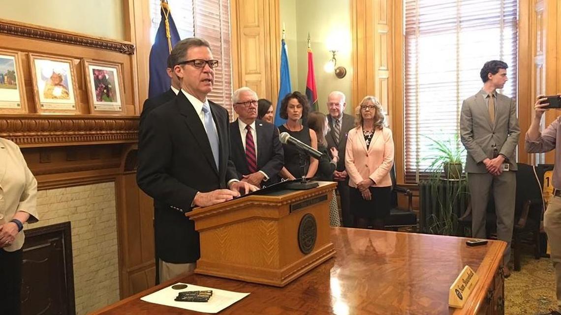 Kansas Gov. Sam Brownback speaks at a June 5 bill signing ceremony, where he discussed another bill, which would prohibit guns at hospitals, with reporters.