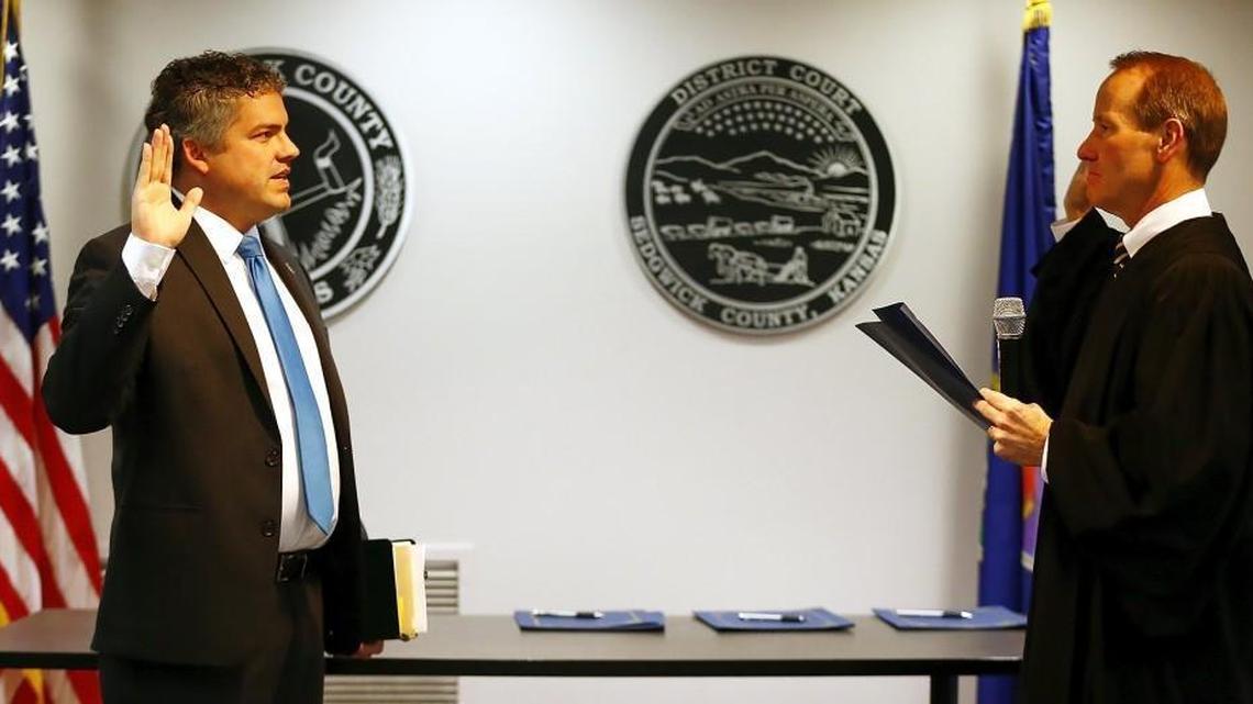 Kelly Arnold, left, takes the oath of office for Sedgwick County Clerk at the Sedgwick County Courthouse in January. Arnold won a third term as Republican state chairman at the party’s annual convention in Manhattan on Saturday.