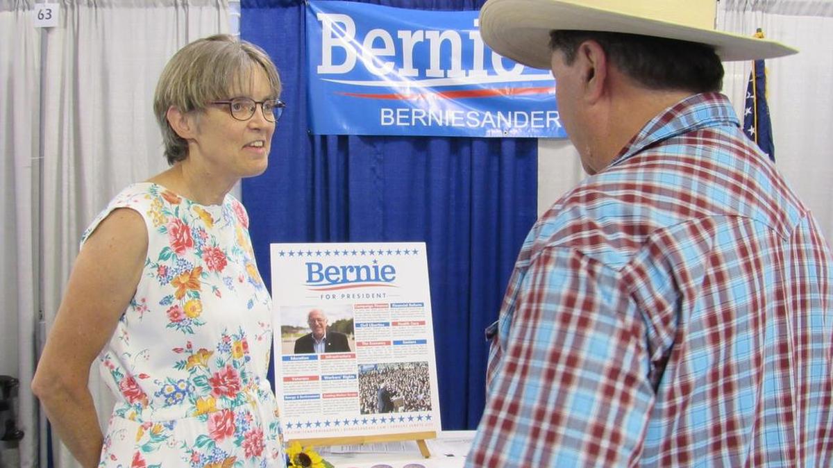  Mary Ann Harmon of Garden Plain pitches Bernie Sanders for president to Dennis Smith at the Kansas State Fair.