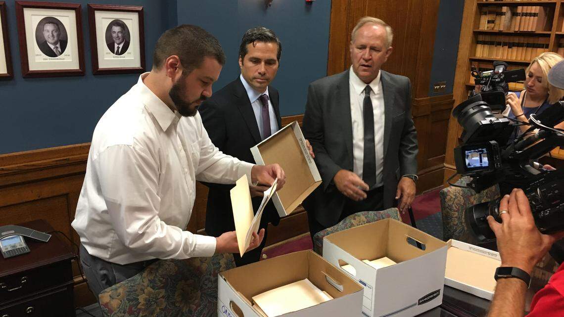 Greg Orman, center, turns in signatures Monday aimed at securing a spot on the November general election ballot in his independent bid for Kansas governor.