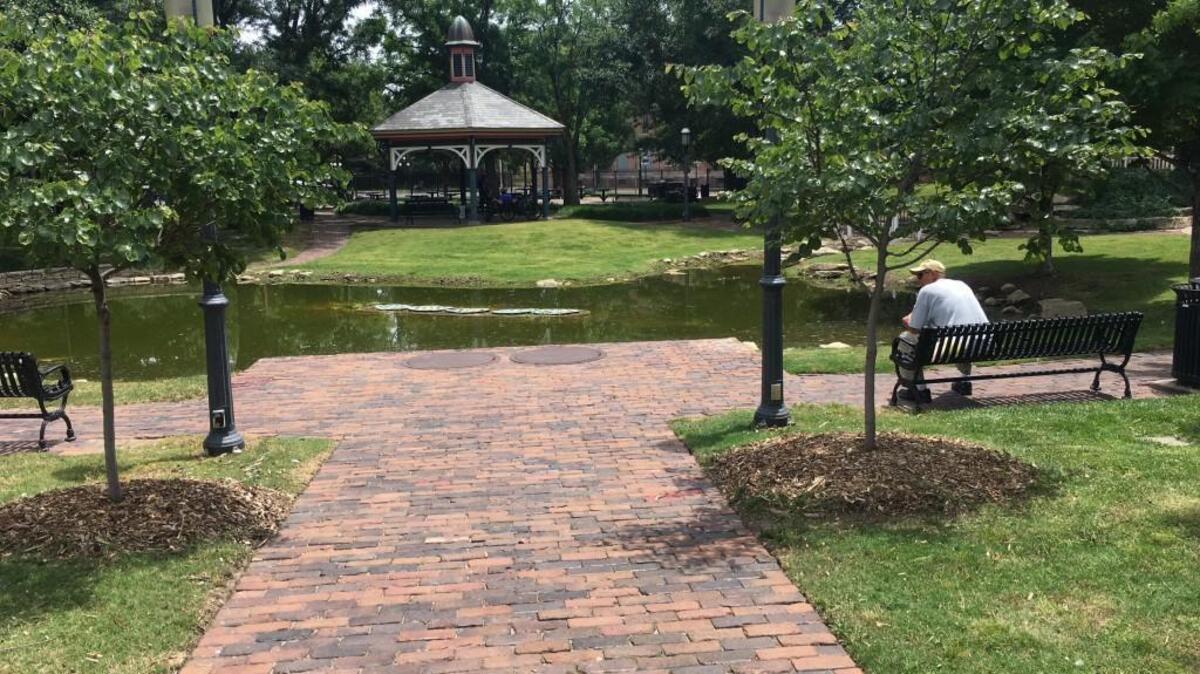 Mark Roland visits Naftzger Memorial Park in downtown Wichita nearly every day. A plan to renovate the park would replace the grass with artificial turf and provide space for live music and other events.