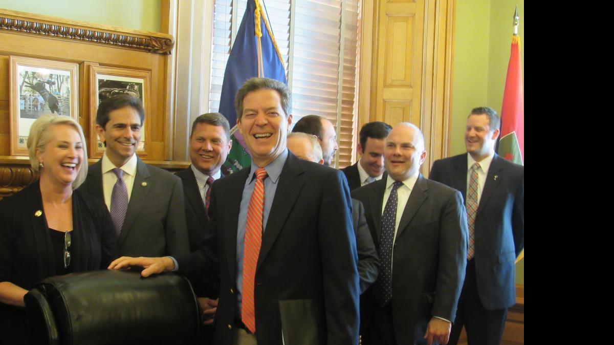 
Gov. Sam Brownback is joined by lawmakers and lobbyists at a bill-signing ceremony Monday. Brownback disclosed that he has relied on private cellphone and e-mail use since his time as a U.S. senator. (May 18, 2015)
