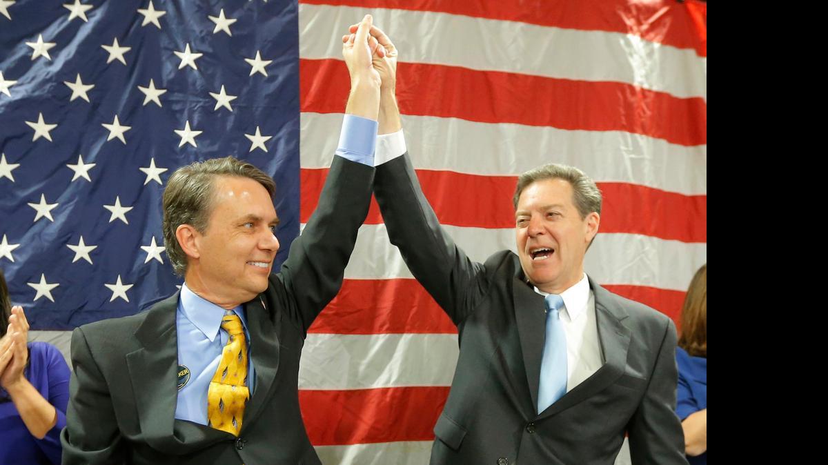 
Gov. Sam Brownback and his running mate Lt. Gov. Jeff Colyer raise their hands to a cheering crowd in Topeka in November after Brownback was re-elected governor.
