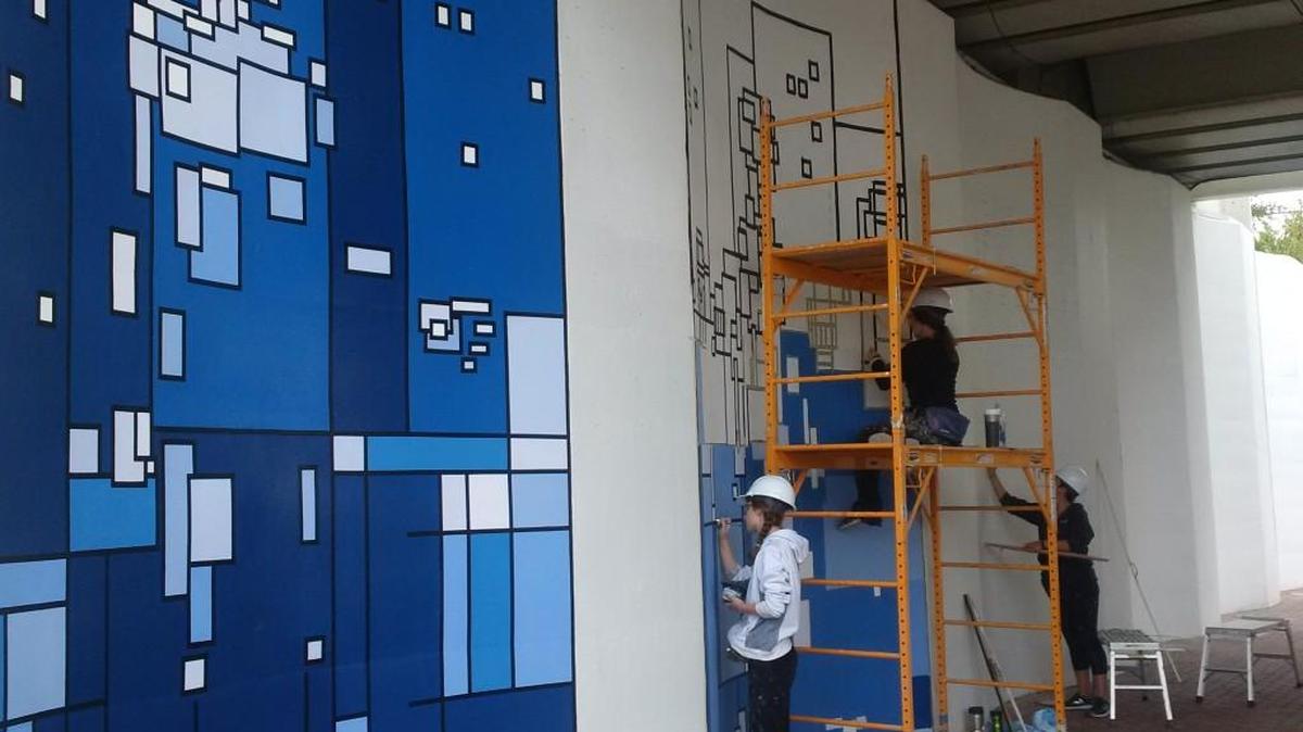 Artists from Danielle Studios have begun painting murals to beautify the railroad crossings in Old Town.