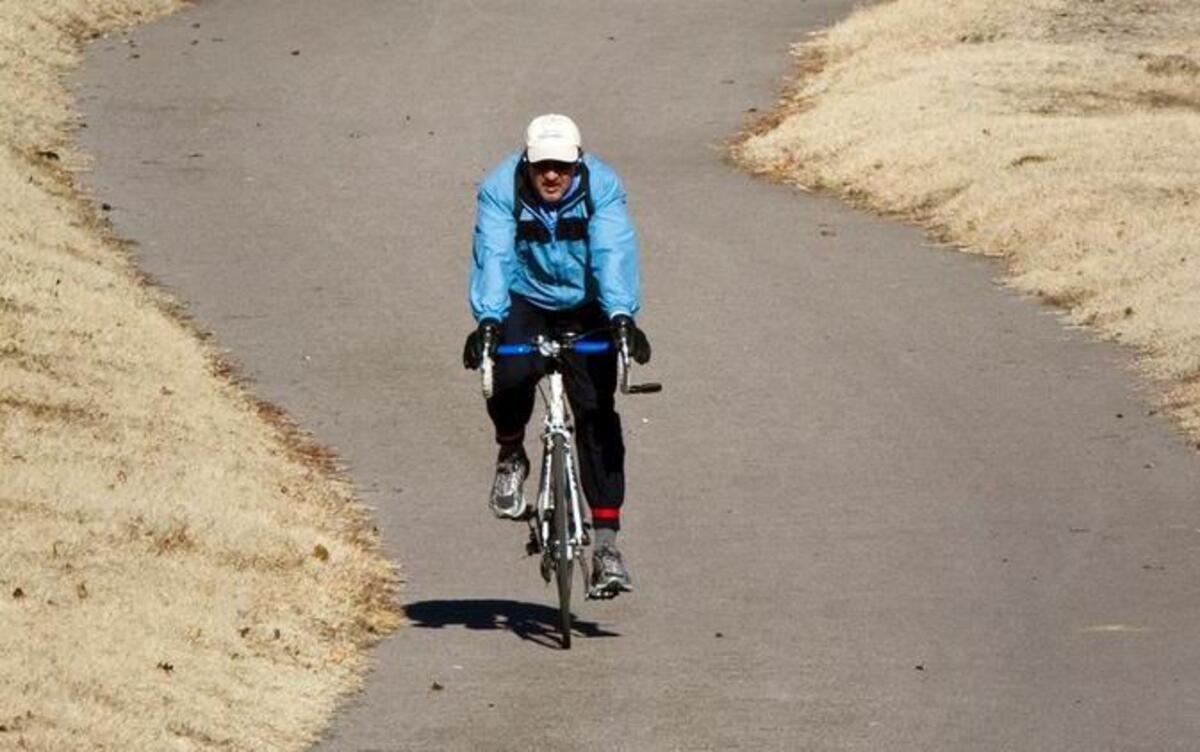 Tom Martin uses the bike path along the Arkansas River between Douglas and Maple. On Tuesday, the City Council voted to spend $1.6 million to expand three trails in the city’s bike path system.
