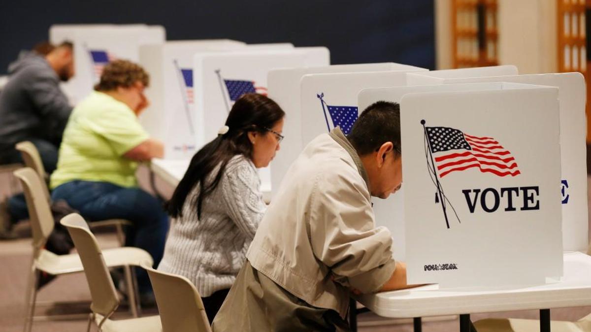 Voters fill out paper ballots at First Mennonite Brethren Church on West 21st Street during the general election on Nov. 8. Voters had choice of paper ballots or machine voting. (Nov. 8, 2016)
