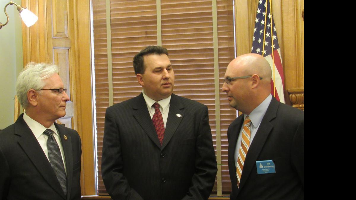 
From left, Rep. Dennis Hedke, R-Wichita, chairman of the House Energy and Environment Committee, Sen. Rob Olson, R-Olathe, chairman of the Senate Utilities Committee, and Jeff Glendening of Americans for Prosperity appear at the announcement of a compromise on renewable energy standards. 
