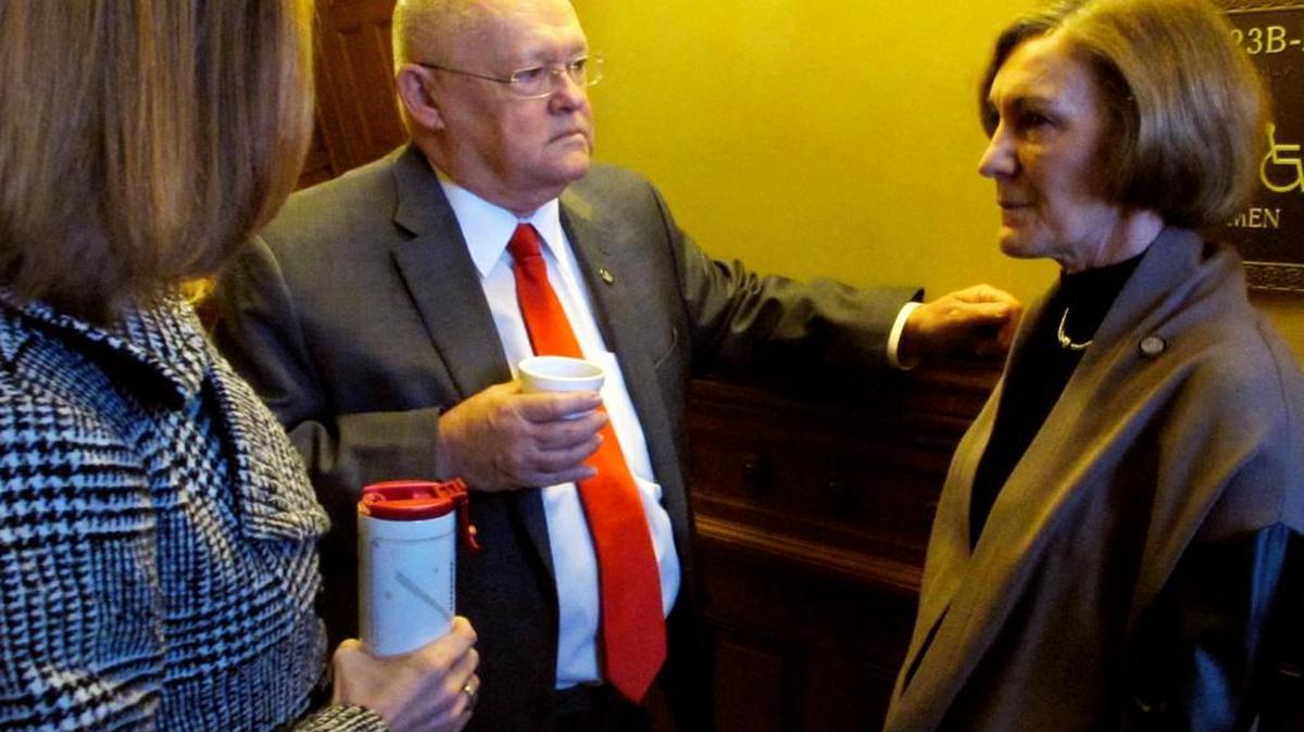 From left, Kansas state Sens. Dinah Sykes, R-Lenexa; John Skubal, R-Overland Park; and Barbara Bollier, R-Mission Hills, confer in a hallway outside the Senate chamber before Republican leaders canceled a debate Thursday over budget-balancing proposals.