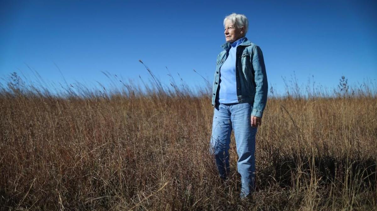 Retired U.S. Sen. Nancy Kassebaum Baker stands among the tallgrass prairie near her home in the Flint Hills.