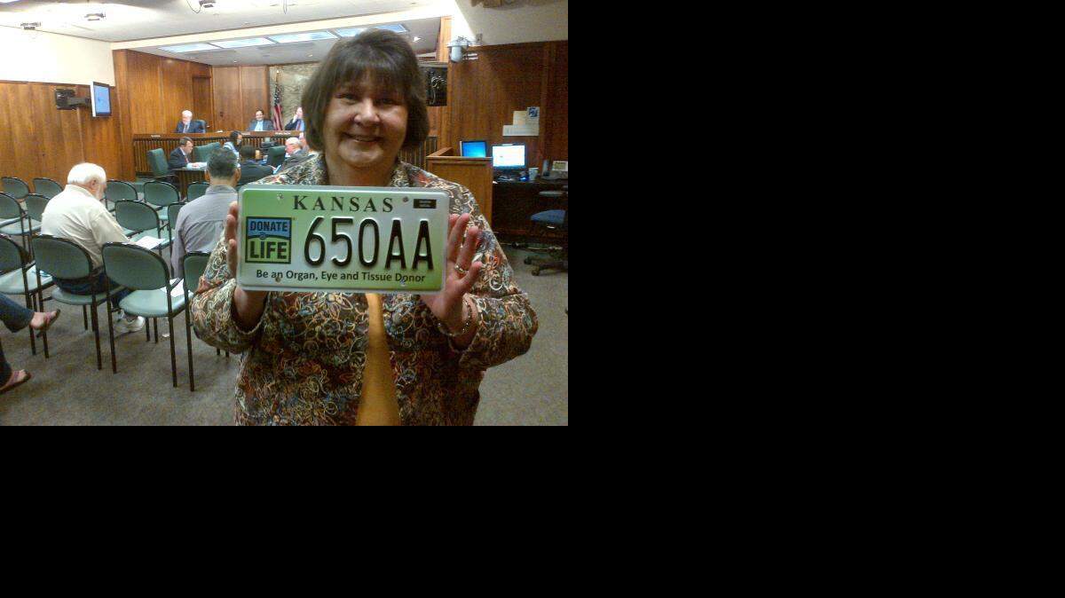 
Sedgwick County Treasurer Linda Kizzire displays the new “Donate Life” license plate Wednesday. (March 11, 2015)
