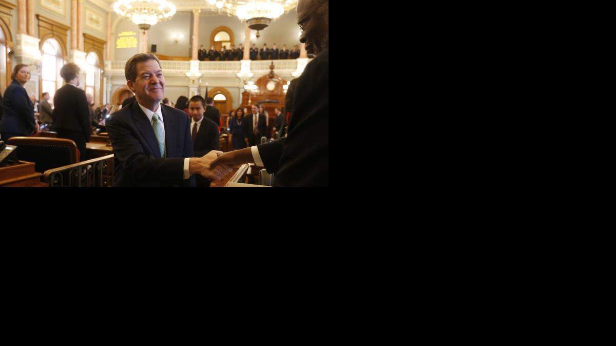 
Gov. Sam Brownback shakes hands as he leaves the Kansas House chambers Monday afternoon after his inauguration as governor of Kansas for a second term.(Jan. 12, 2015) 
