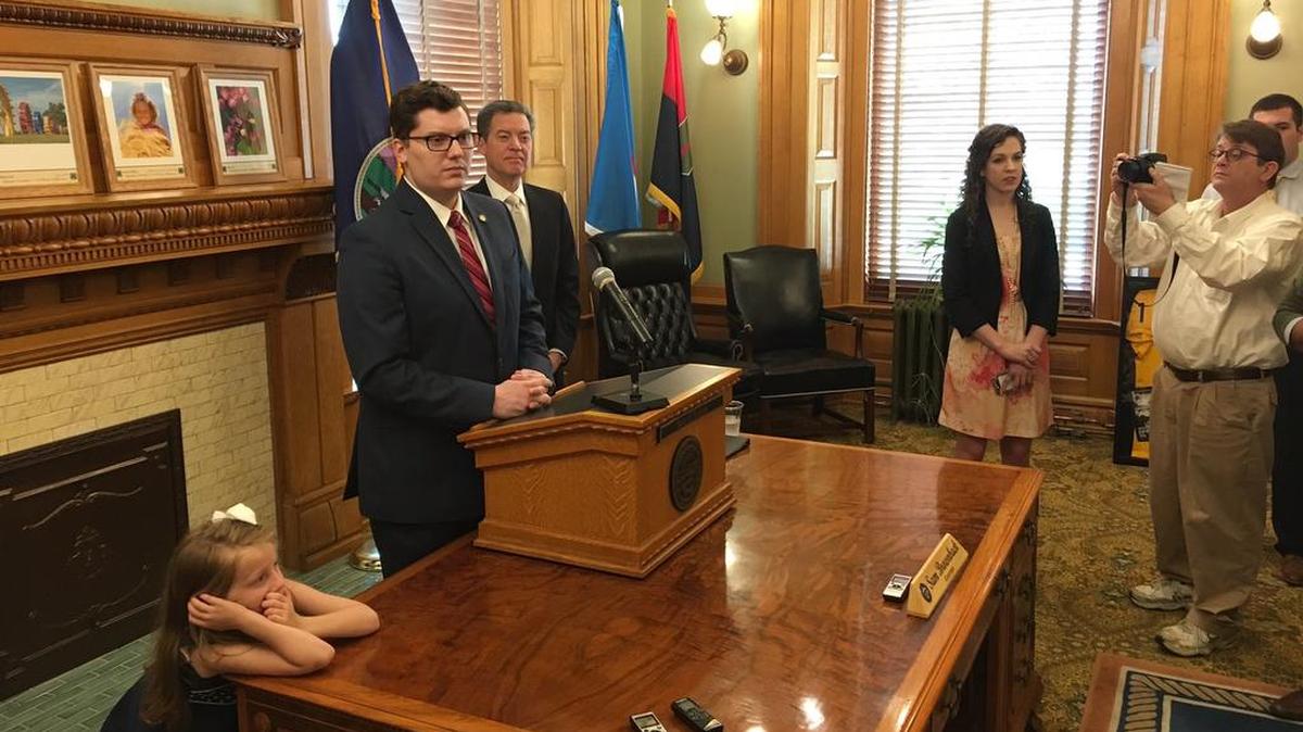 Kansas Sen. Jacob LaTurner, pictured at the podium Tuesday morning in the governor’s office, will serve as the state’s new treasurer.