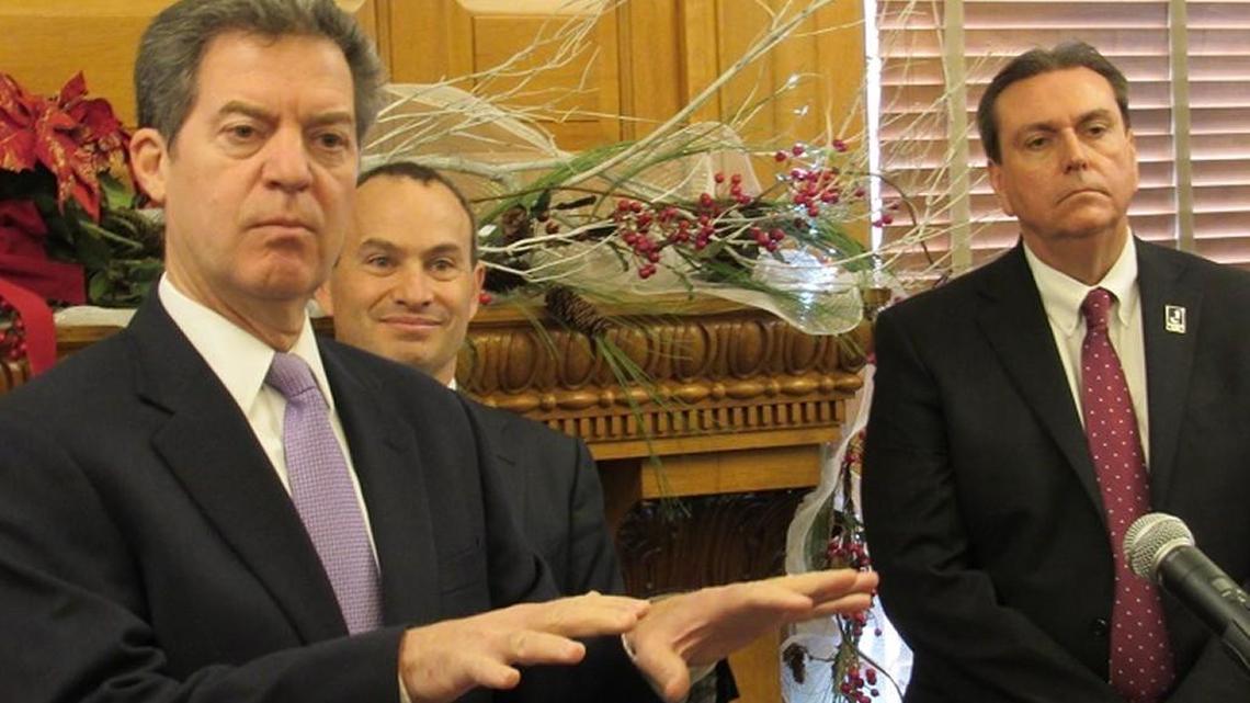 Gov. Sam Brownback is joined by Education Commissioner Randy Watson, right, and Evan Marwell, the founder of EducationSuperHighway, a nonprofit that will help Kansas provide high speed Internet to digital schools.