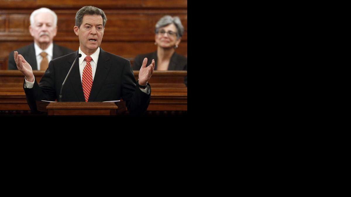 
Kansas Gov. Sam Brownback addresses a joint session of the Kansas House and Senate Thursday night during the annual State of the State address. Behind the governor is Speaker of the House Ray Merrick (left) and Senate President Susan Wagle. 
