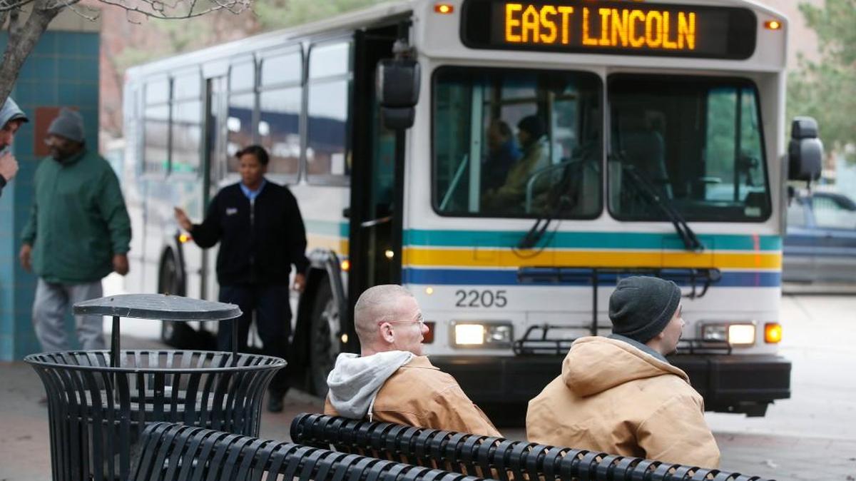 Riders wait for a bus at the Downtown Wichita Transit center. County and city officials disagree over Wichita Transit’s role in future growth plans. (Dec. 15, 2014)